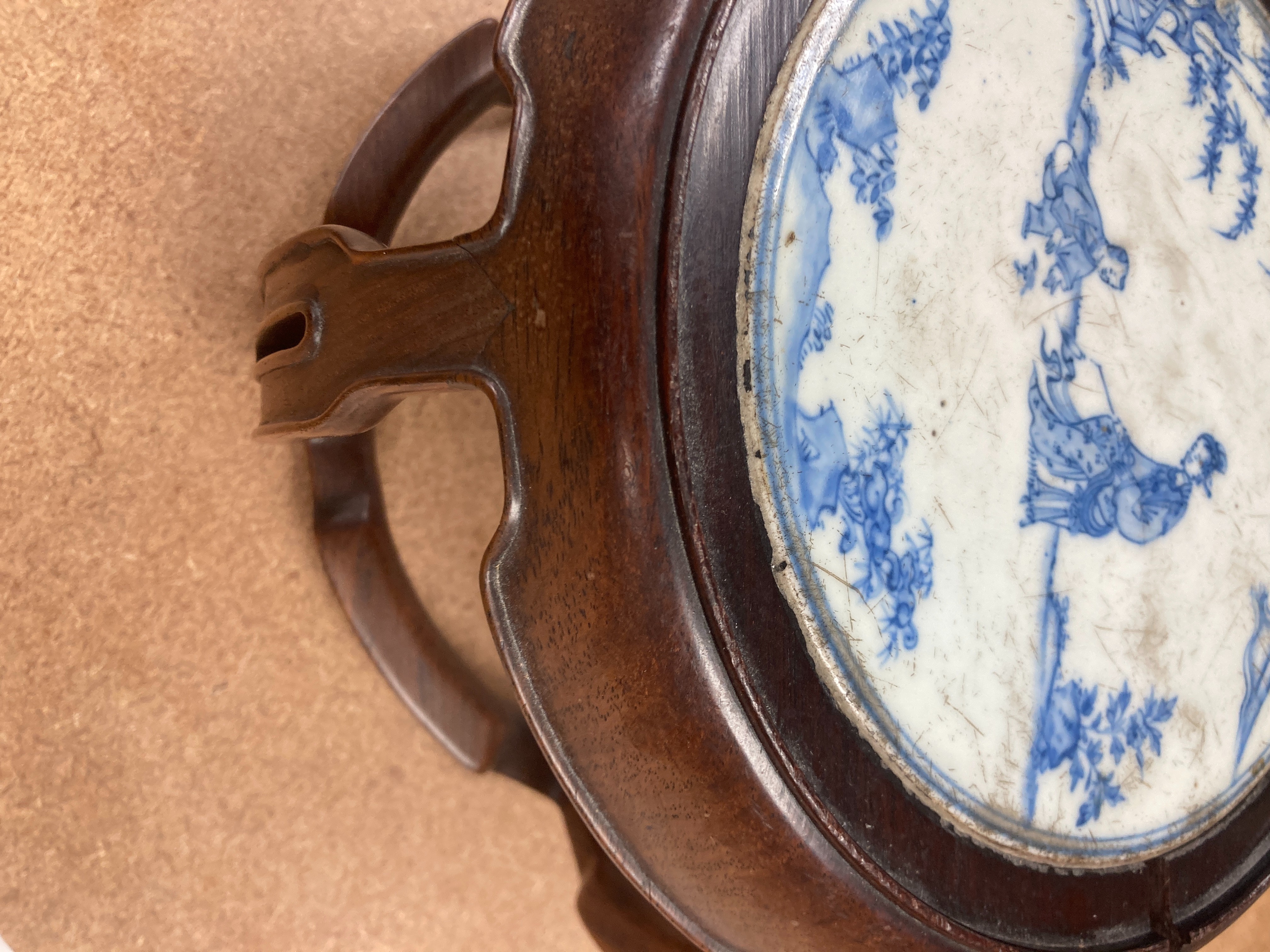 A 19th century Chinese blue and white circular tile inset hongmu stand, 22cm